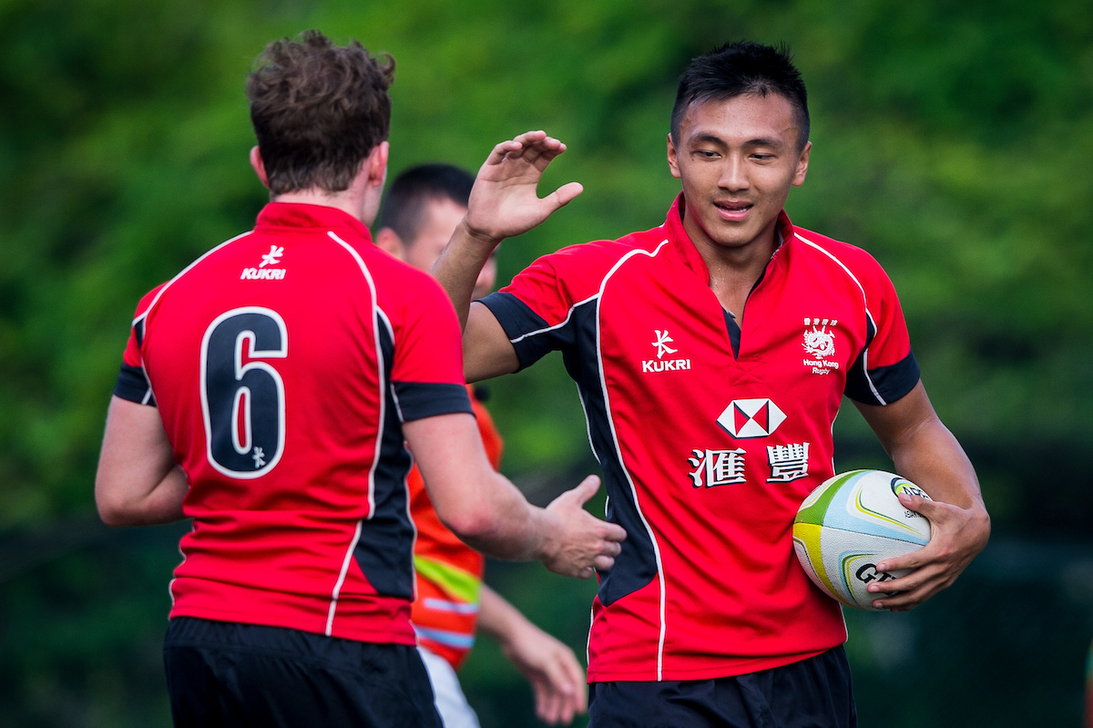 Erick Kwok (right) high five with his U20 teammates